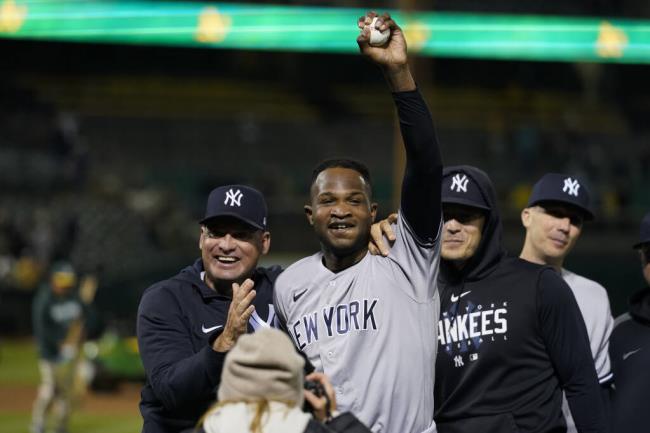 New York Yankees' Domingo Germán, center, celebrates after pitching a perfect game against the A’s in Oakland, Wednesday, June 28, 2023. The Yankees won 11-0. (Godofredo A. Vásquez / ASSOCIATED PRESS)