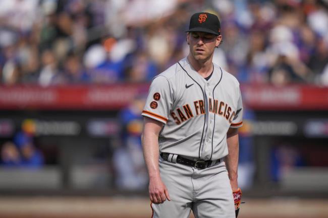 Giants pitcher Anthony DeSclafani reacts after giving up three solo home runs in the third inning of Saturday’s game against the Mets in New York. (John Minchillo / ASSOCIATED PRESS)