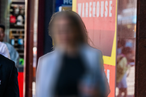 A 46-year-old woman leaves the NSW District Court during her trial on charges of sexual assault against a 14-year-old boy.