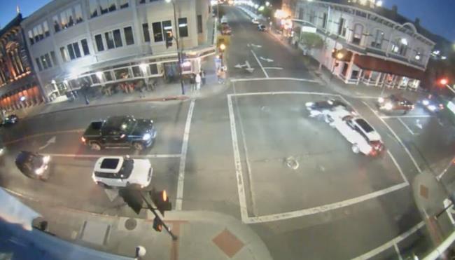 A white SUV was headed on First Street toward Main Street as people stood waiting to cross the street. As the light turned to yellow, the vehicle committed to making the light — driving toward the First Street Bridge, according to security camera footage of the crash. (Napa Police Department)