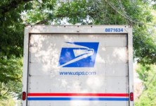 Mail man reaches out of his truck to deliver mail. Official mail delivery slowdown started on October 1, 2021, as seen on October 2, 2021.